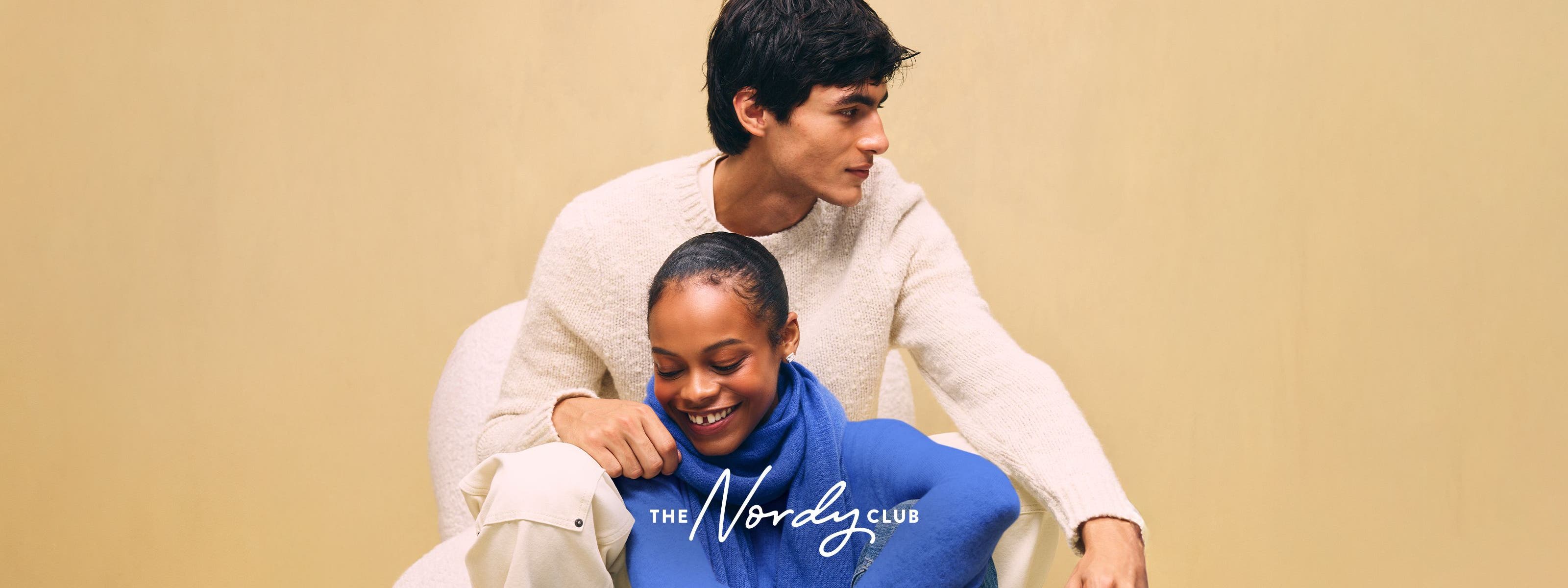 A couple wearing cozy sweaters.