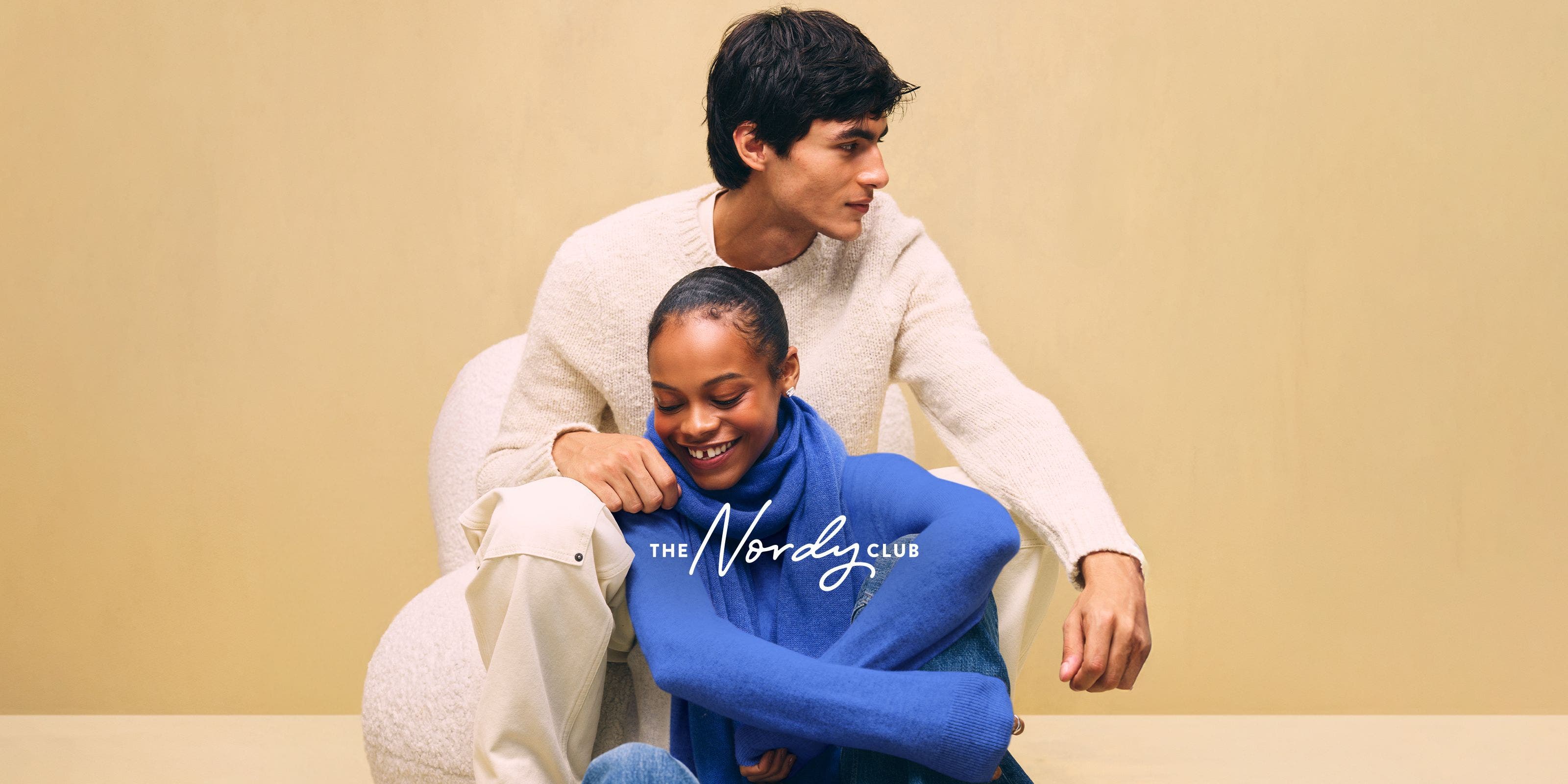 A couple wearing cozy sweaters.