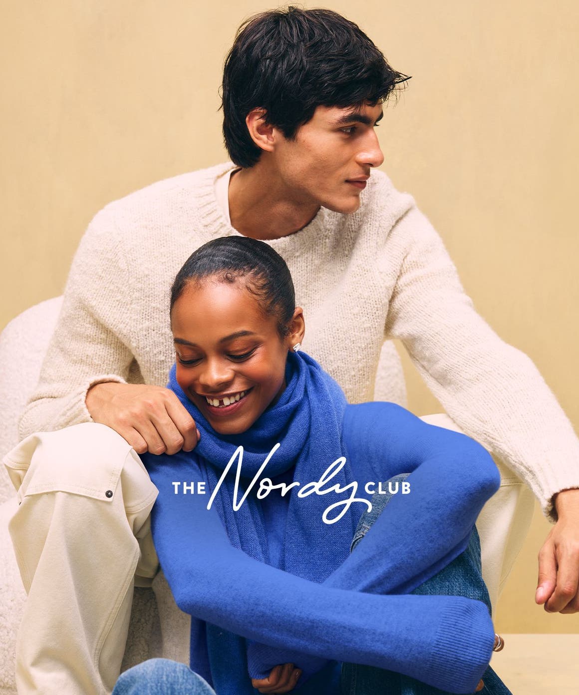 A couple wearing cozy sweaters.