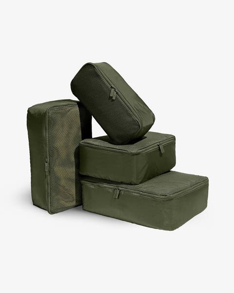 Four green packing cubes in various sizes.