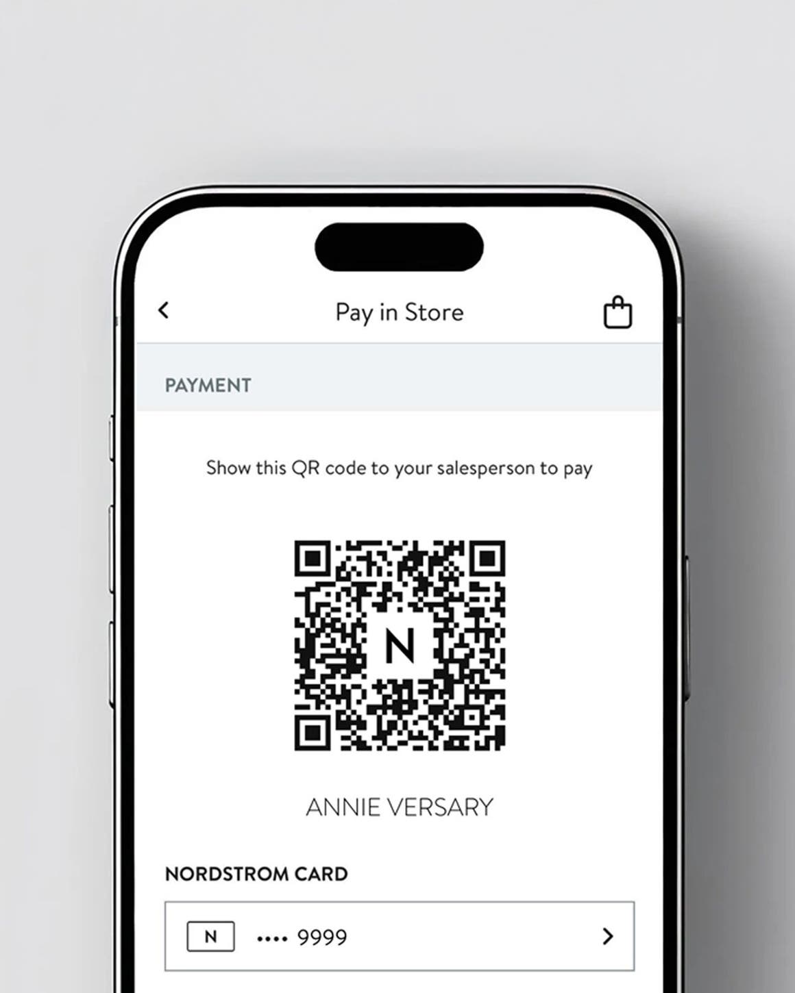Phone showing QR code in app to shop in-store.