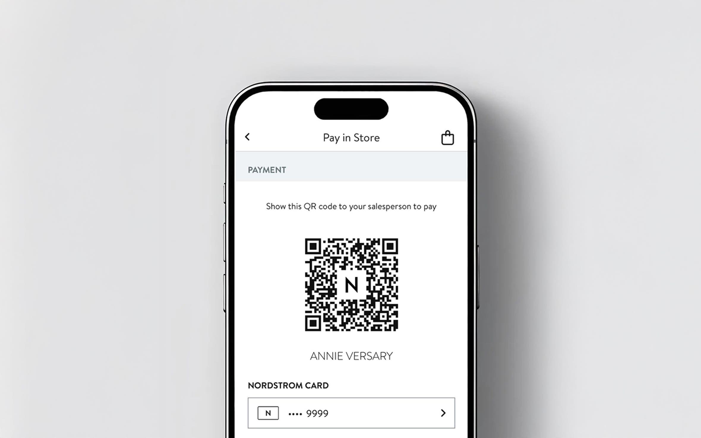 Phone showing QR code in app to shop in-store.