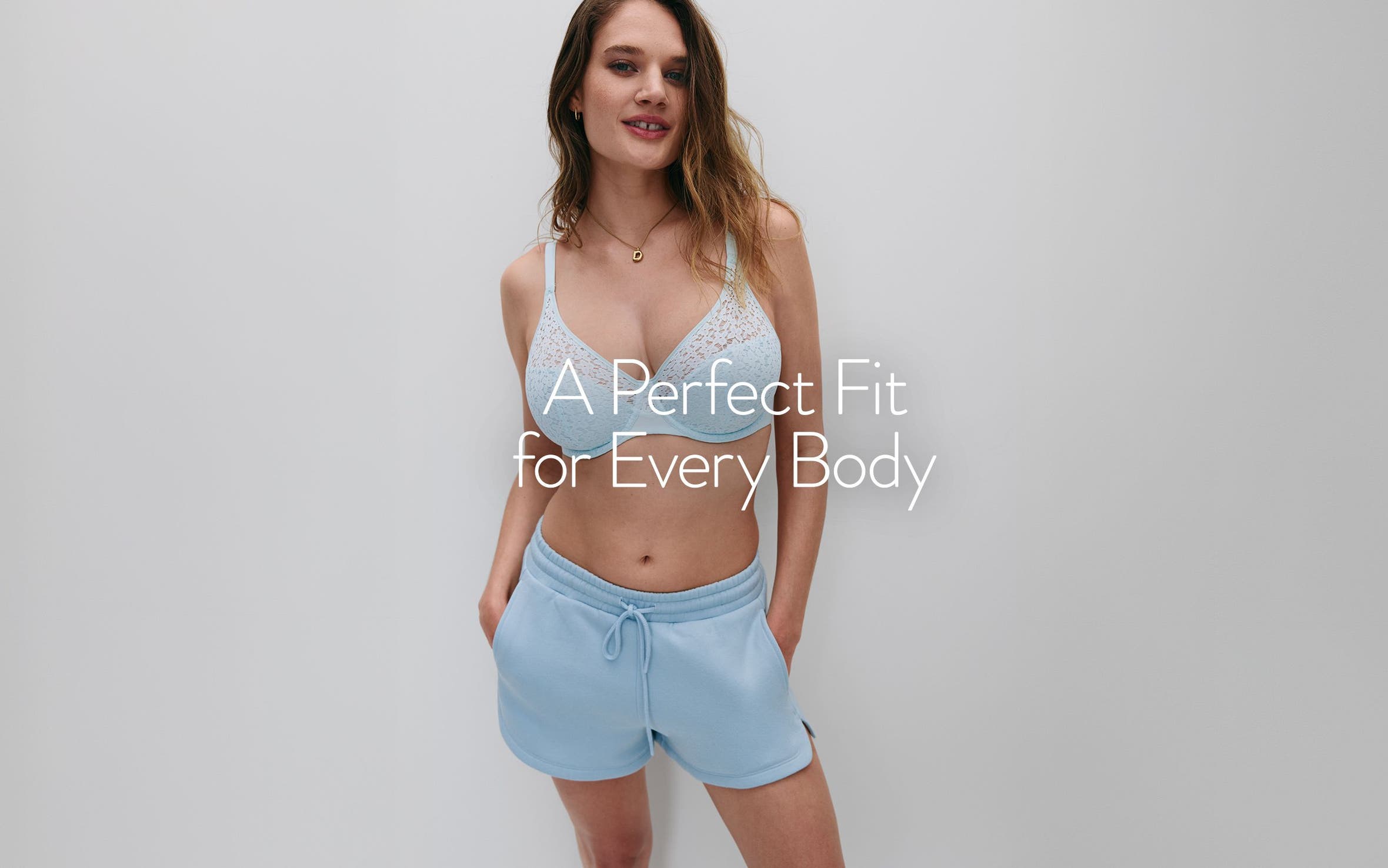 A perfect fit for every body. A woman wearing a bra and lounge shorts.