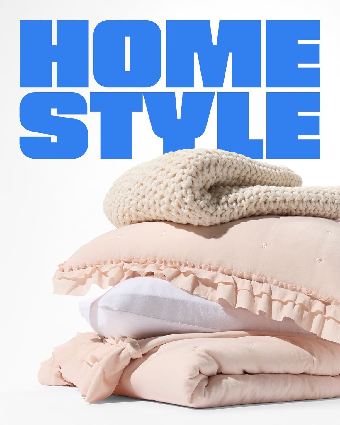 A stack of blankets, duvets and pillows.