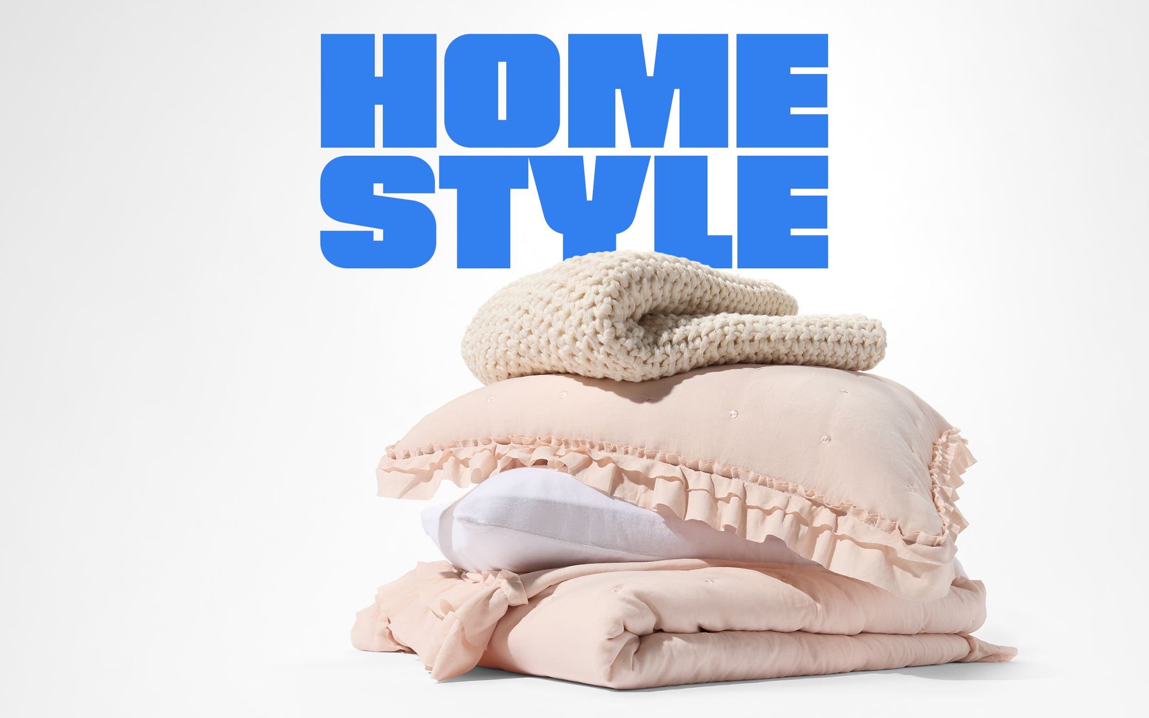 A stack of blankets, duvets and pillows.