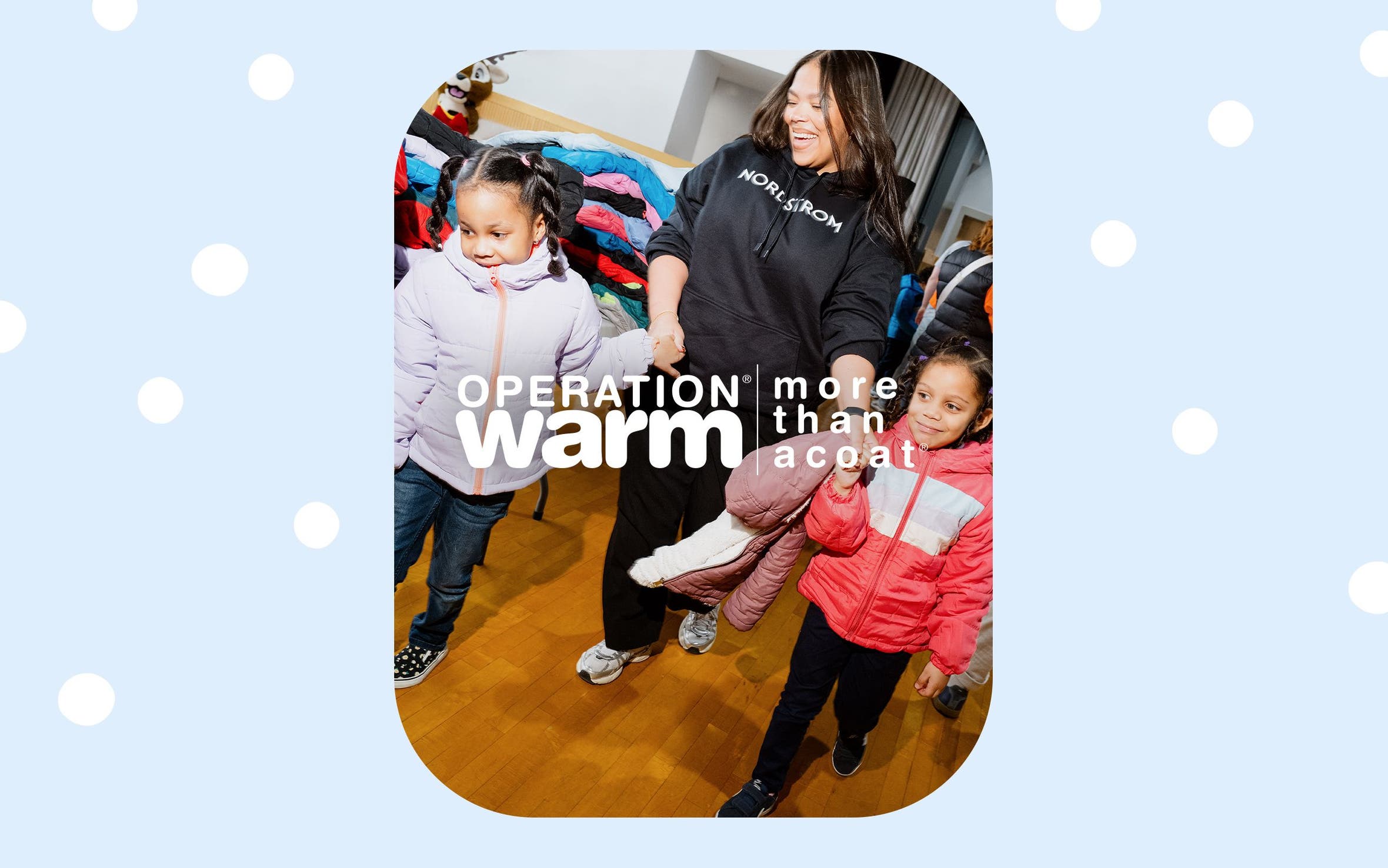 A Nordstrom volunteer with kids in their new coats.