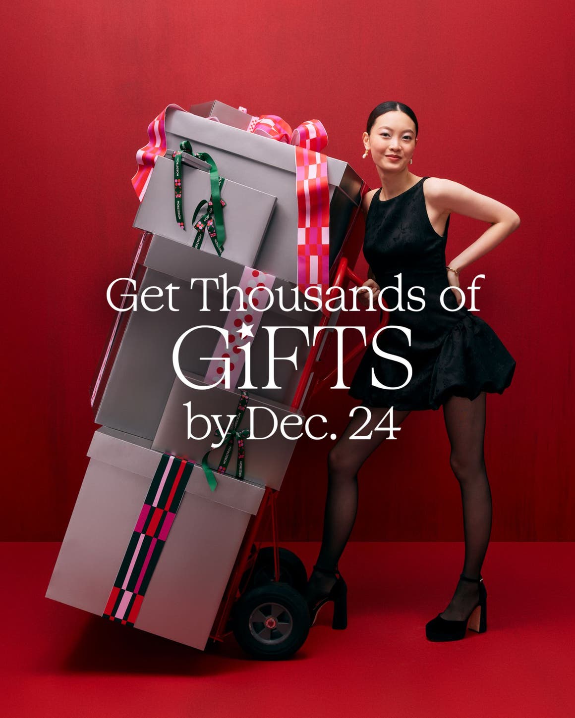 A woman with a stack of gift boxes.