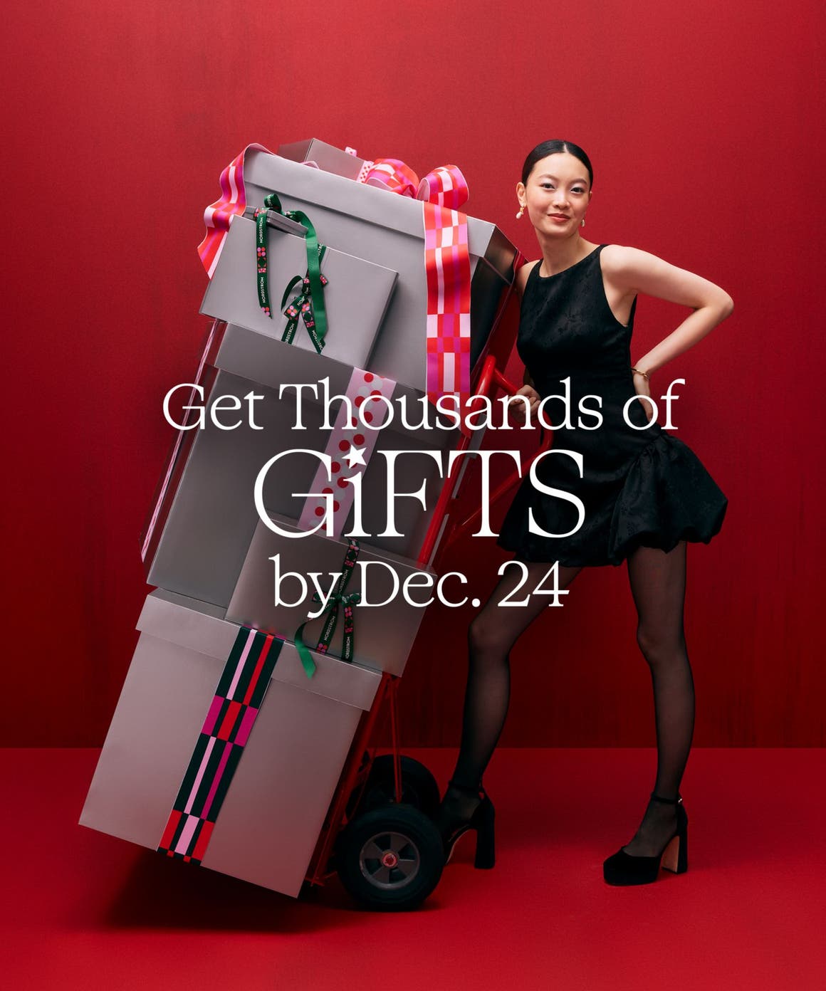 A woman with a stack of gift boxes.