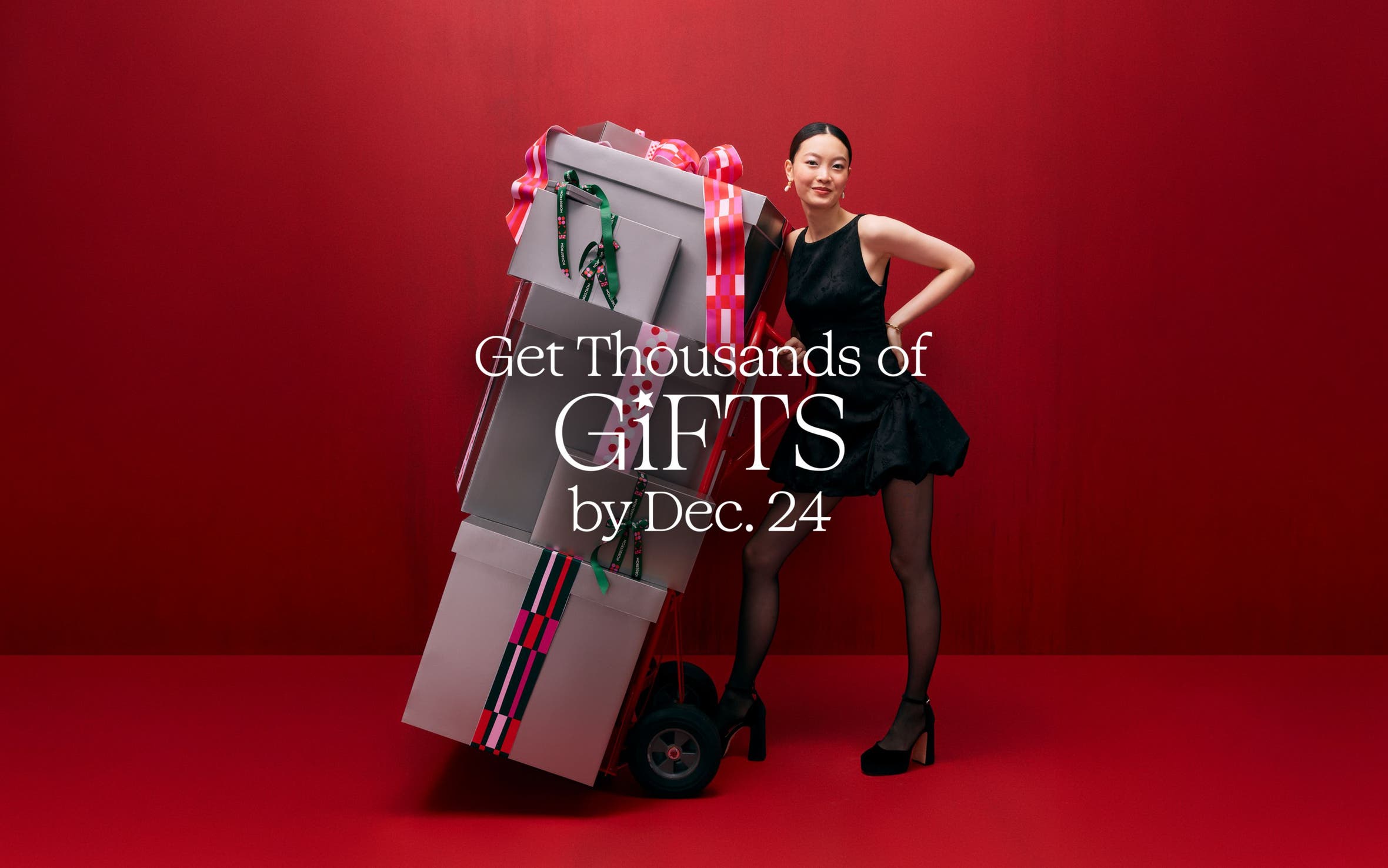 A woman with a stack of gift boxes.