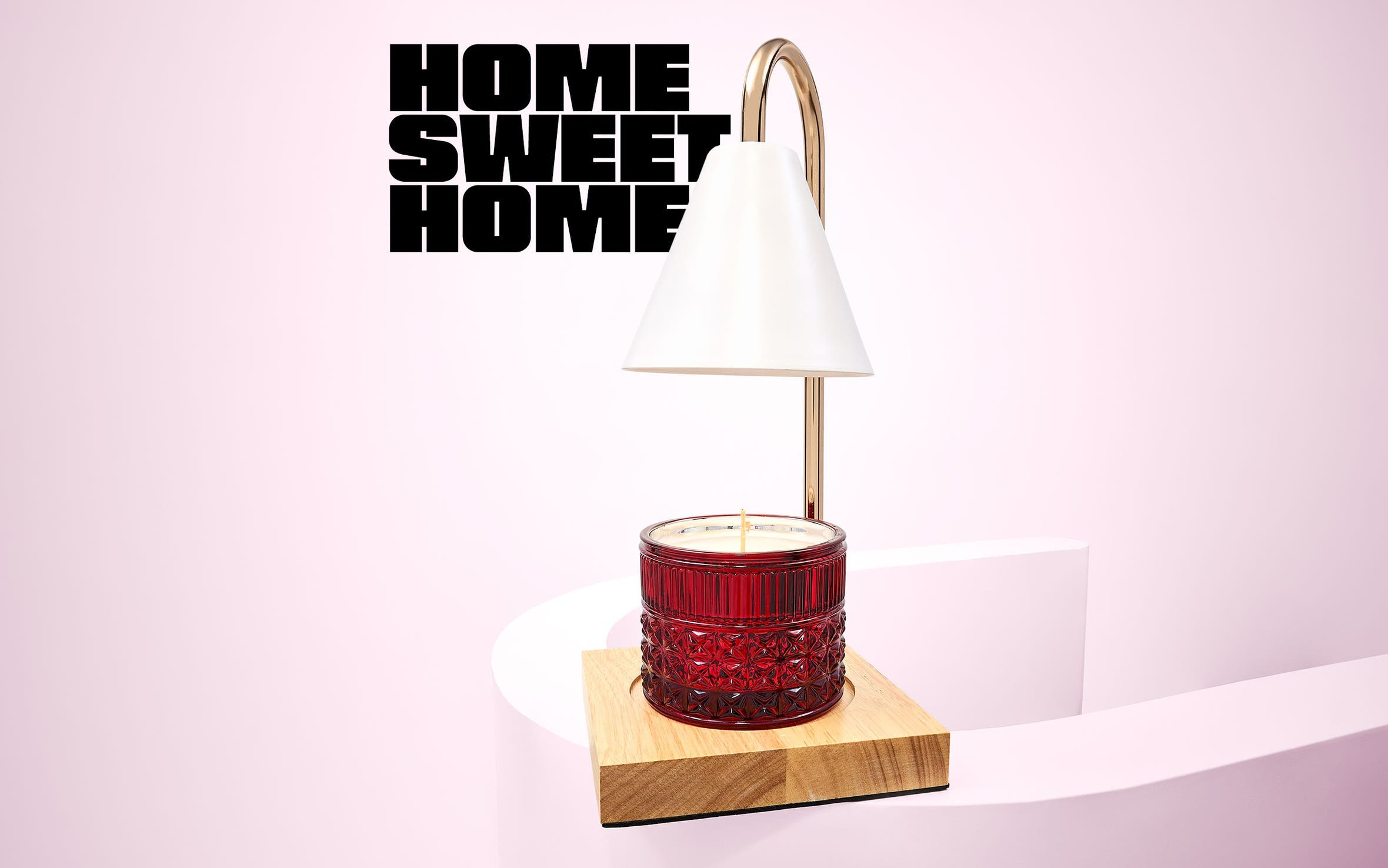 Gold candle warmer with a red candle.