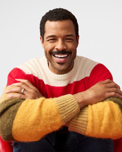 A man wearing a striped sweater. 