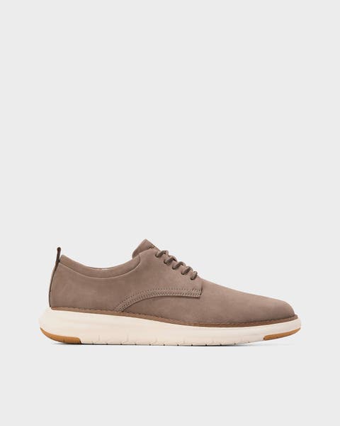 A tan lace-up shoe.