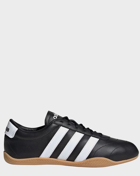 A woman’s black adidas sneaker.