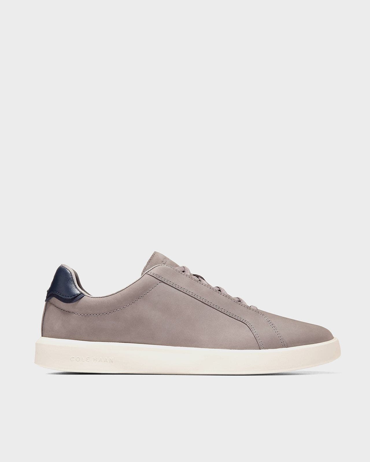 A tan Cole Haan sneaker.