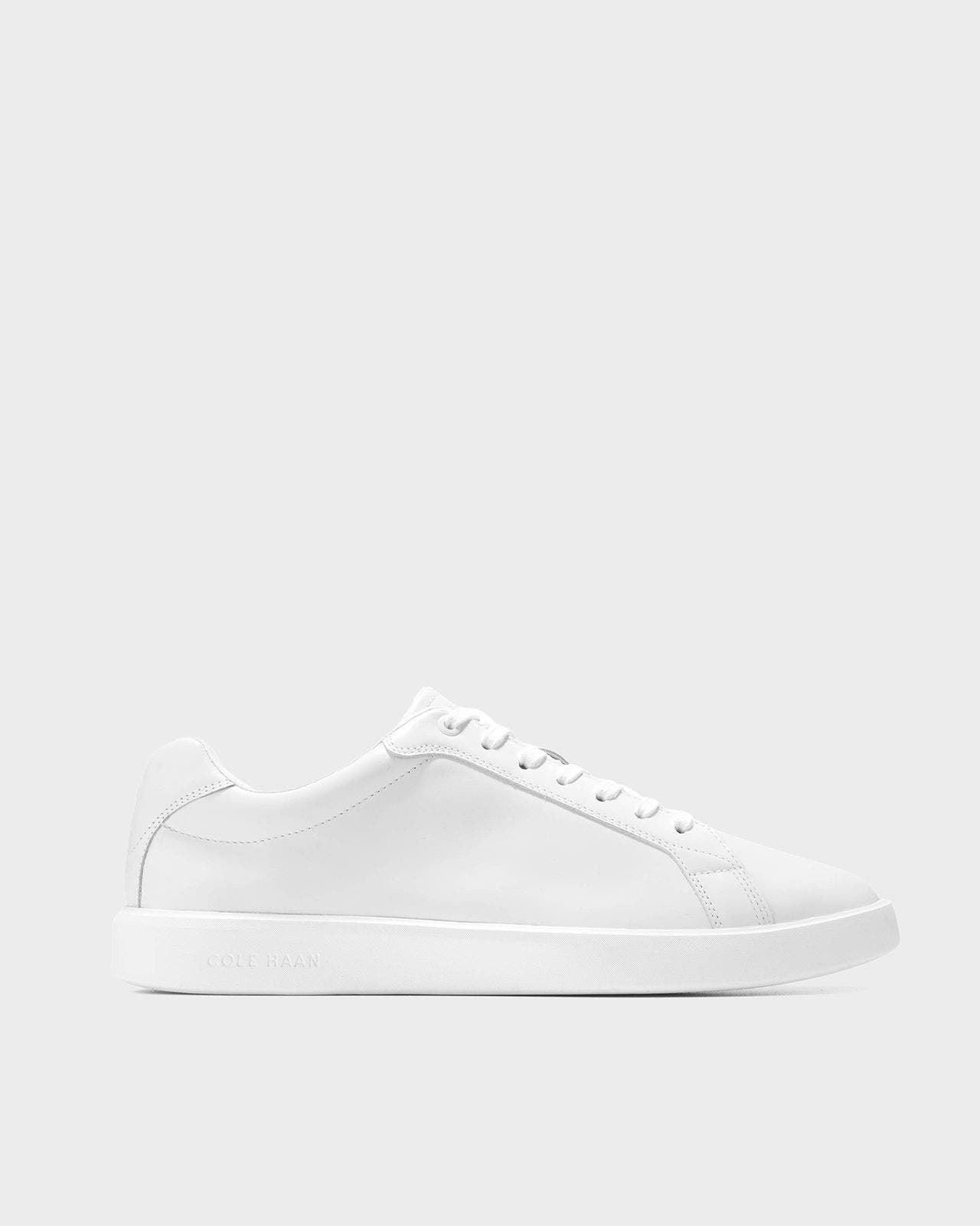 A white Cole Haan sneaker. 