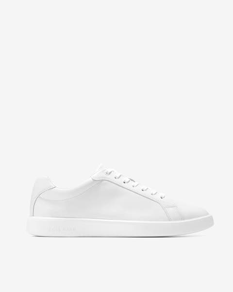 A white Cole Haan sneaker. 