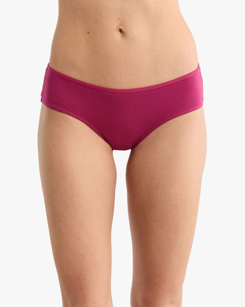 A woman wearing burgundy panties.