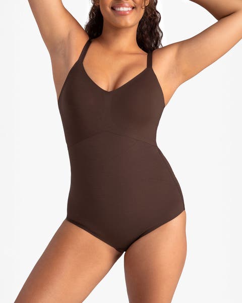 A woman wearing a brown bodysuit.