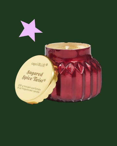 A candle in a red jar.