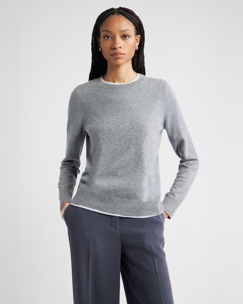 Woman wearing a gray sweater.