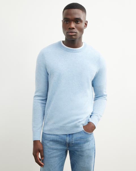 Man wearing a cashmere sweater and jeans.