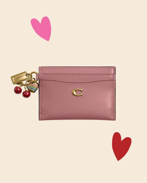 A Coach card case with charm. 