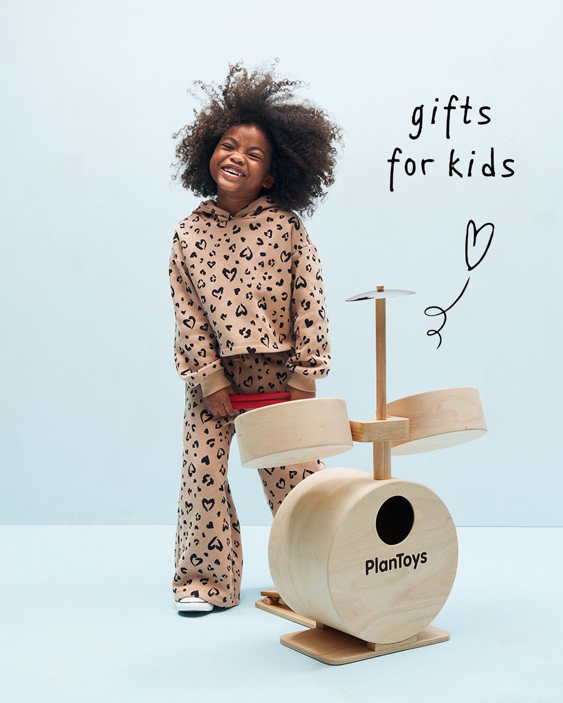 Gifts for kids. A girl and a drum playset. 