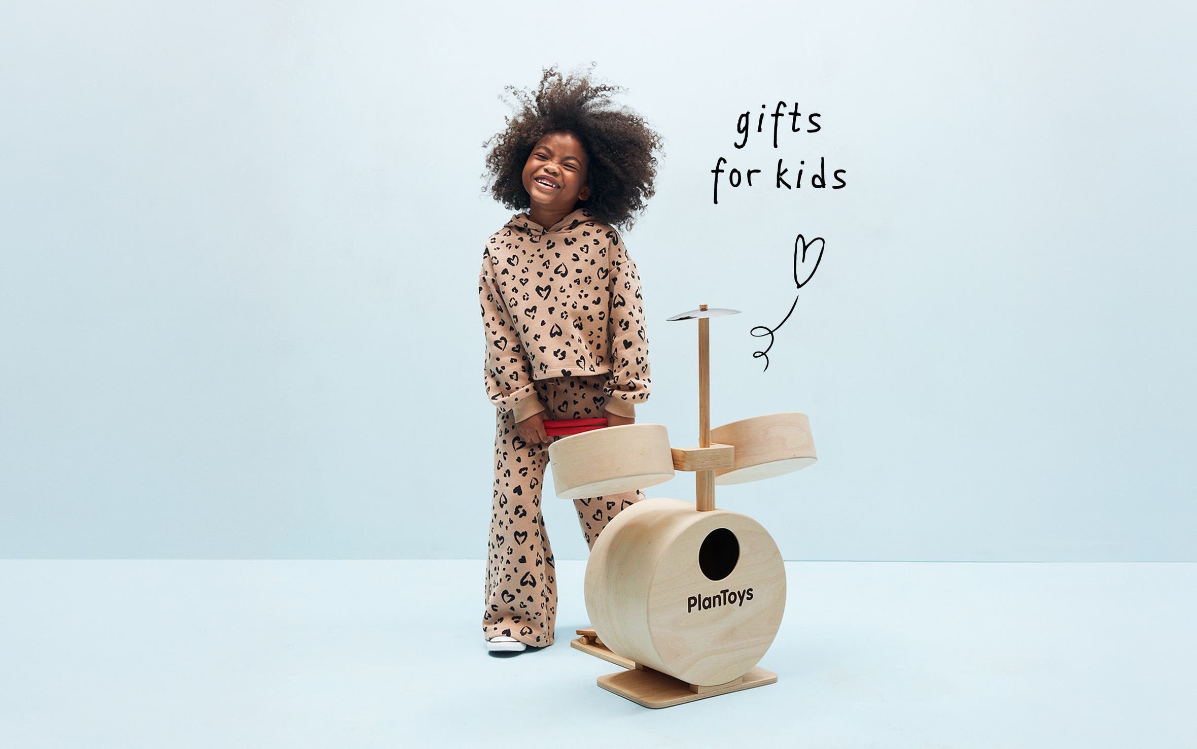Gifts for kids. A girl and a drum playset. 