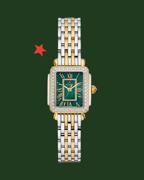 A gold and silver watch with a green face.