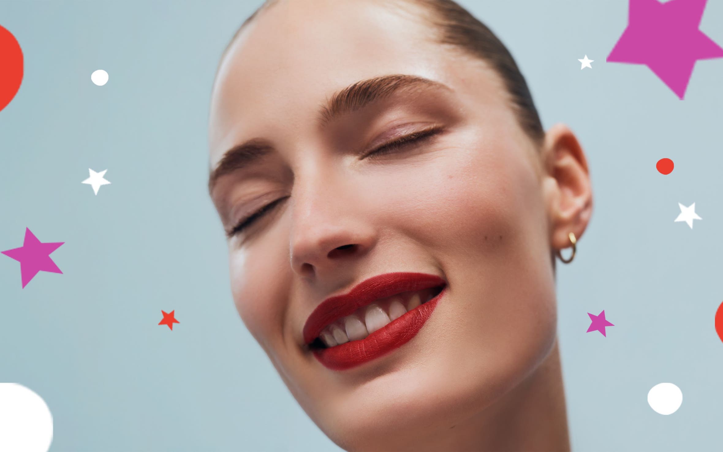 A woman smiling with eyes closed.