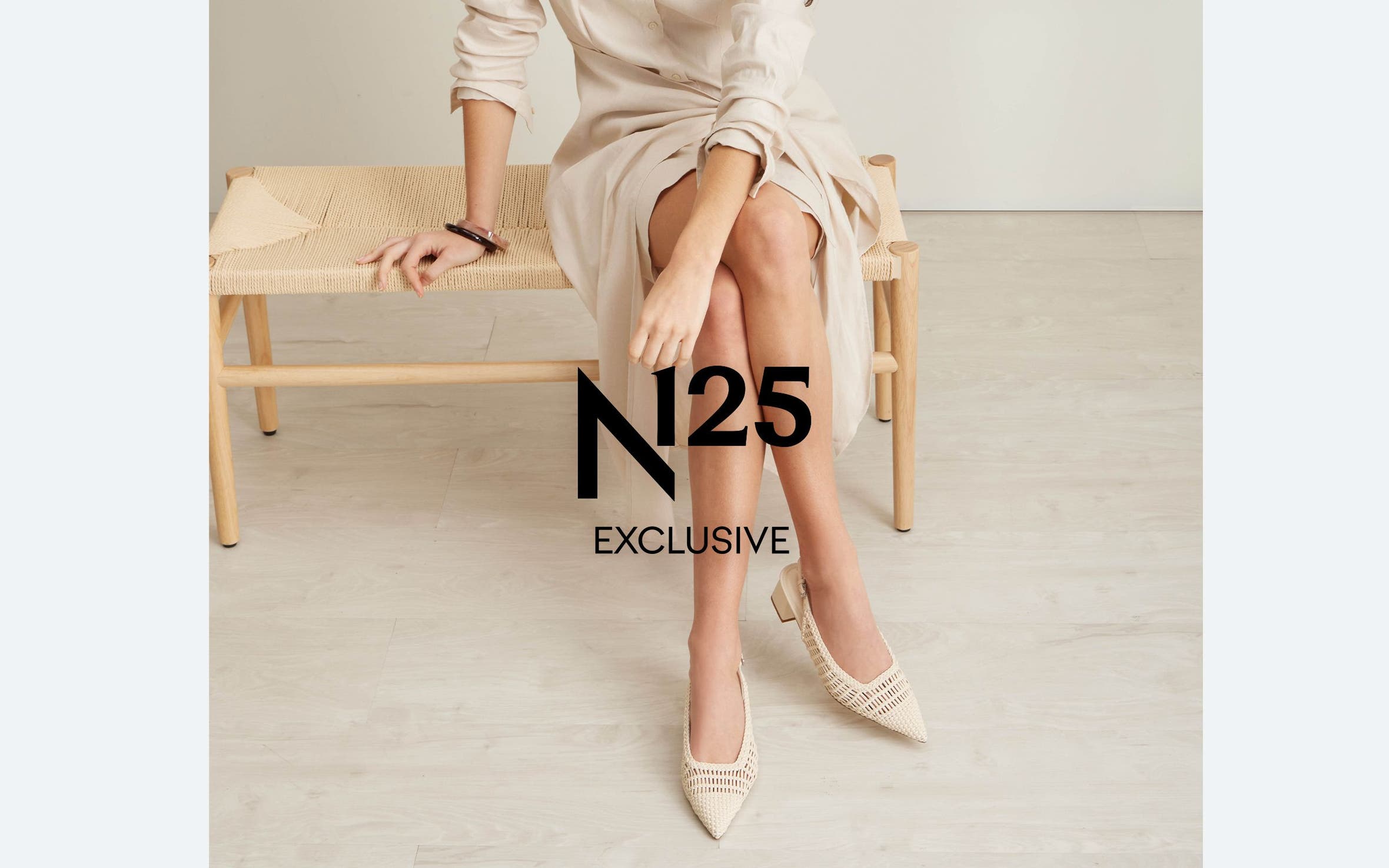 N125 exclusive. A woman wearing woven slingbacks.