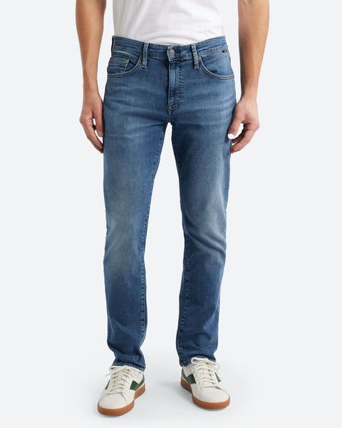 A man wearing slim-straight-fit jeans.