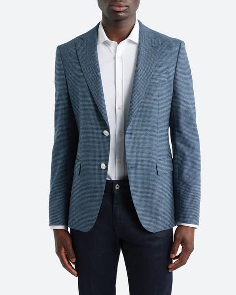 A man wearing a BOSS blazer.