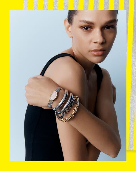 A woman wearing bracelets and a watch.