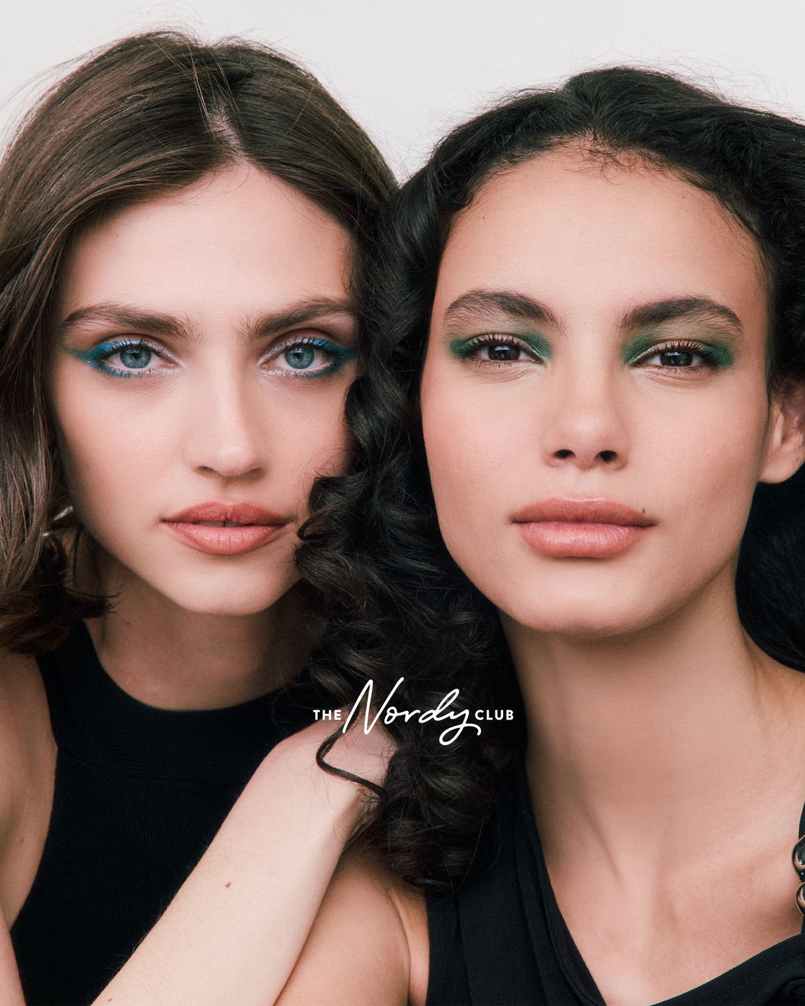 Two woman with made-up eyes. 