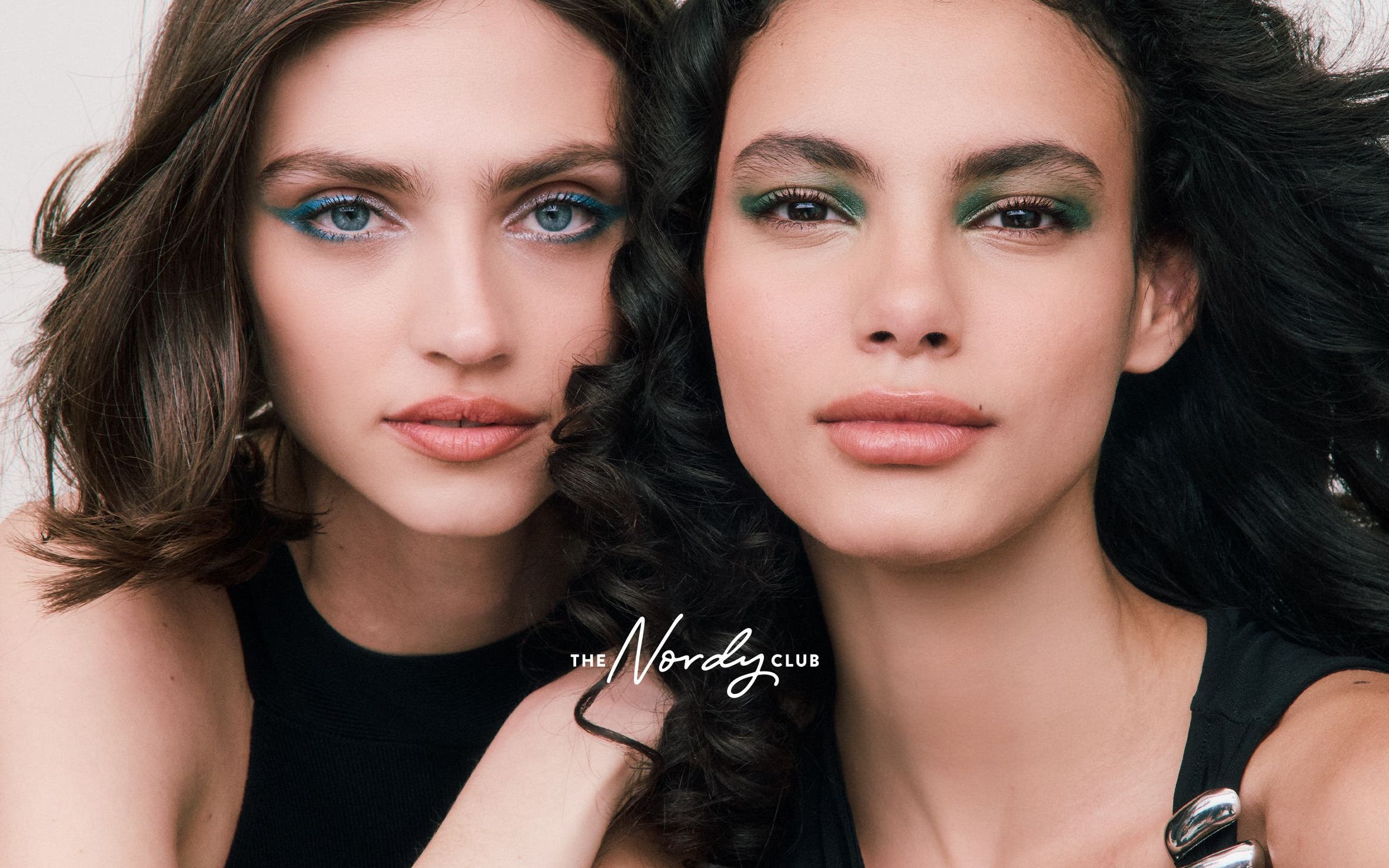 Two woman with made-up eyes. 