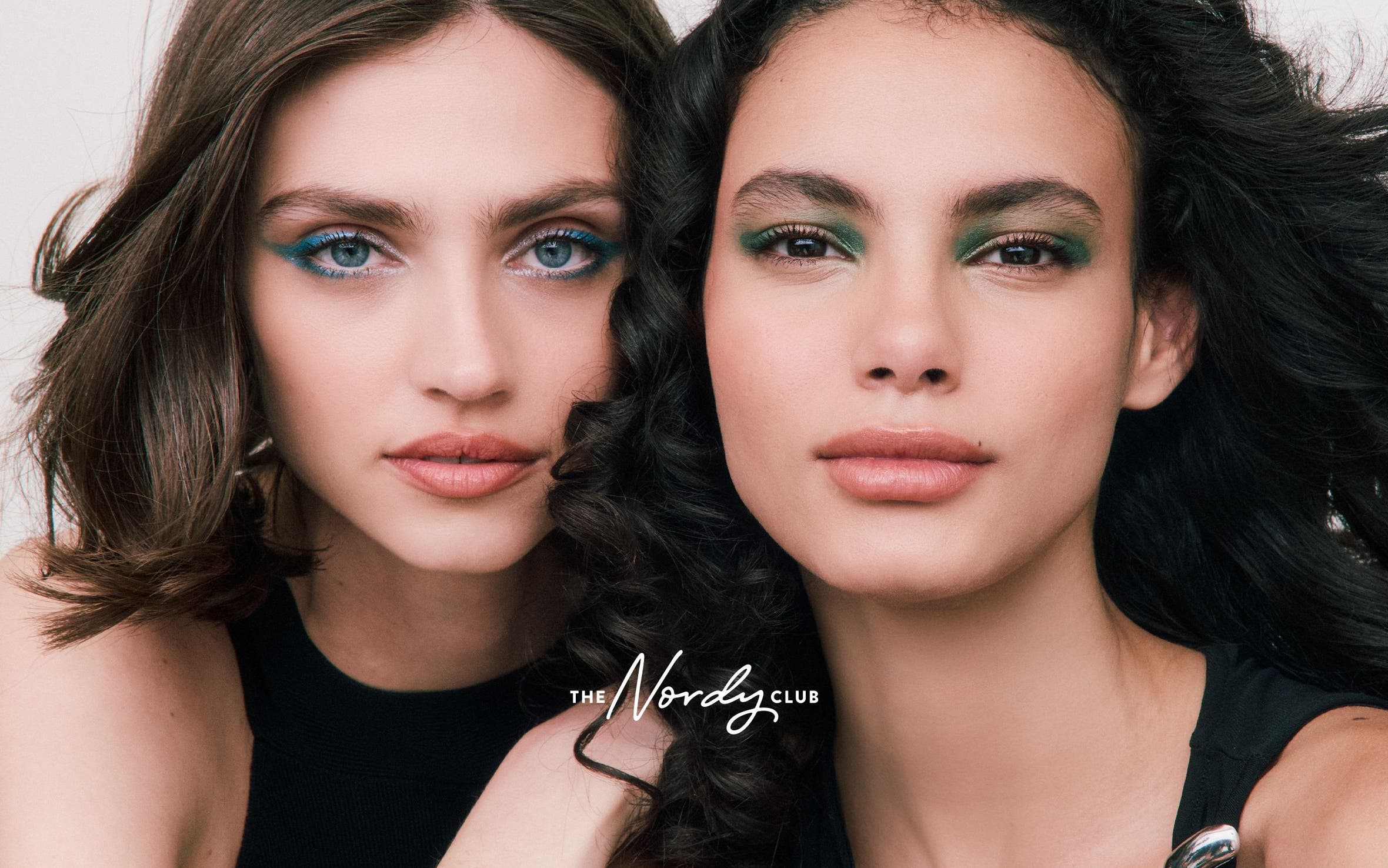 Two woman with made-up eyes.