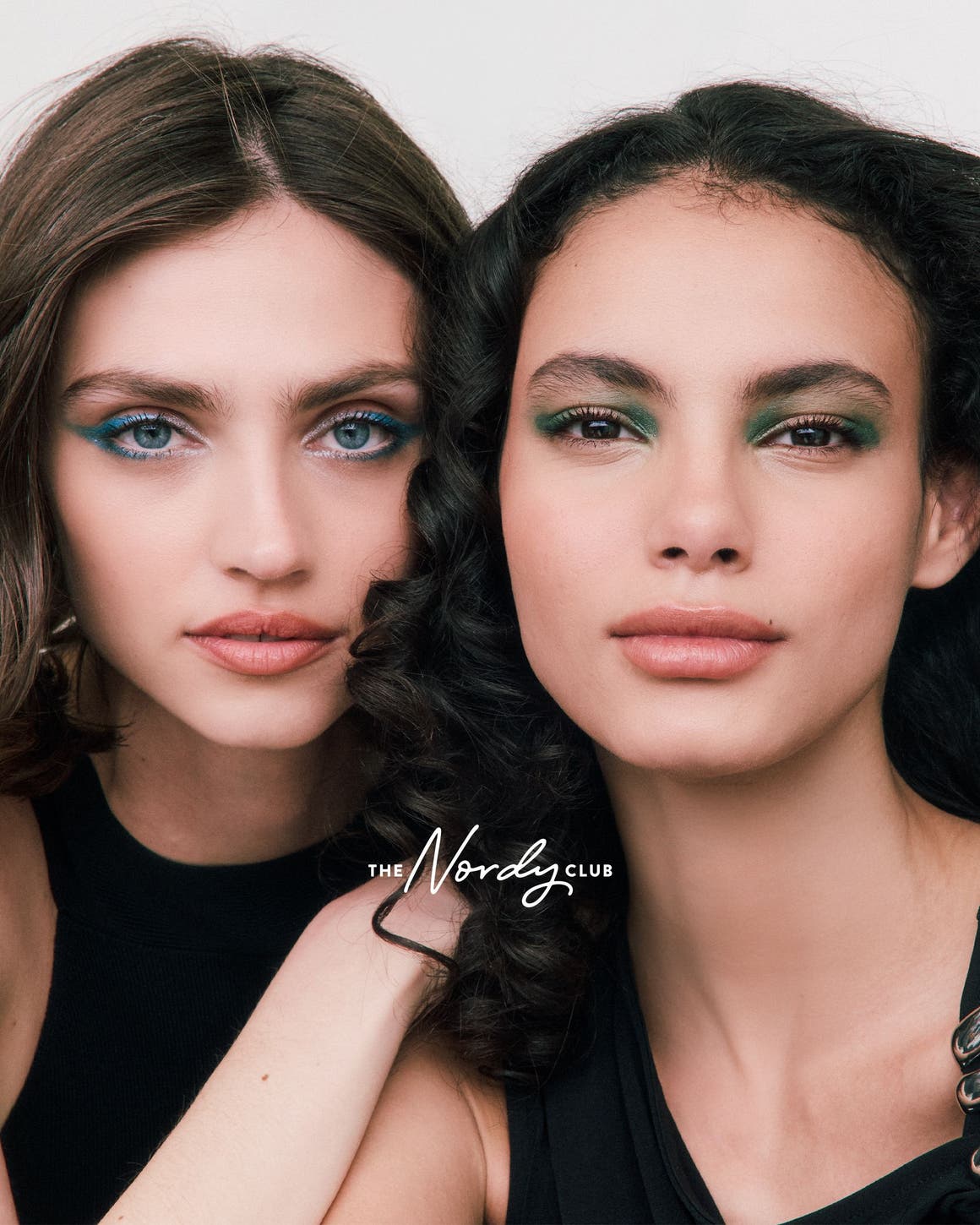 Two woman with made-up eyes.