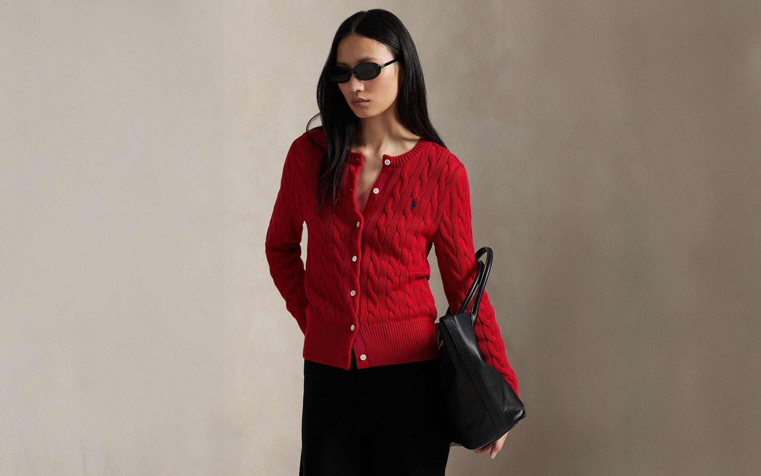 A woman wearing a red cardigan.