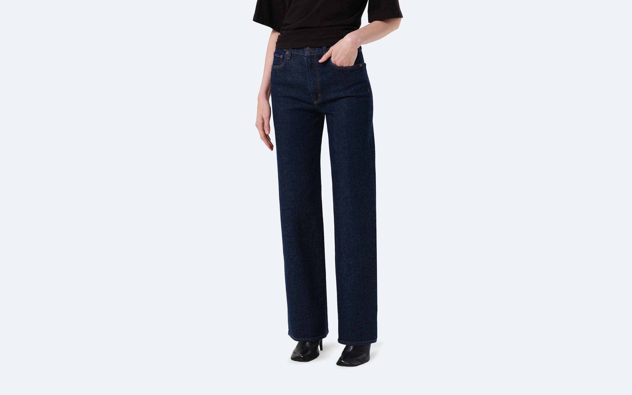 A woman wearing straight-leg jeans.