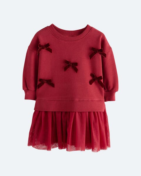 Bow-trimmed red sweatshirt dress with attached skirt.