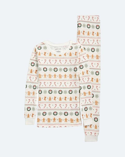 Holiday PJs printed with wreaths and candy canes.