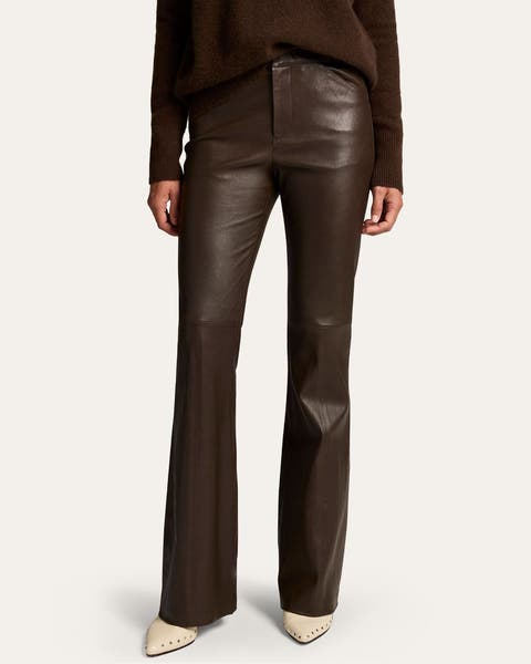 A woman wearing burgundy leather pants.