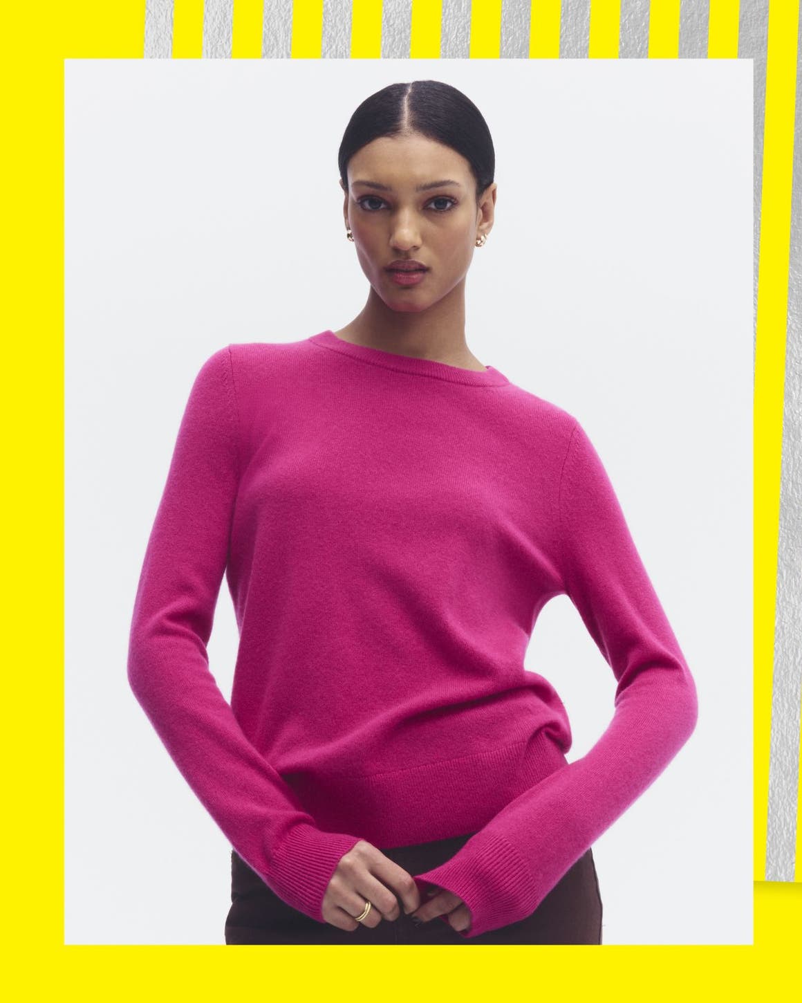 A woman wearing a pink sweater.