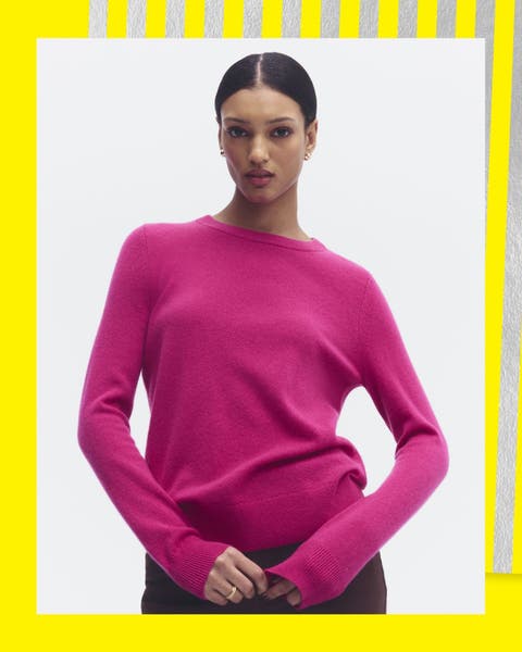 A women in a pink long-sleeve crew neck sweater.
