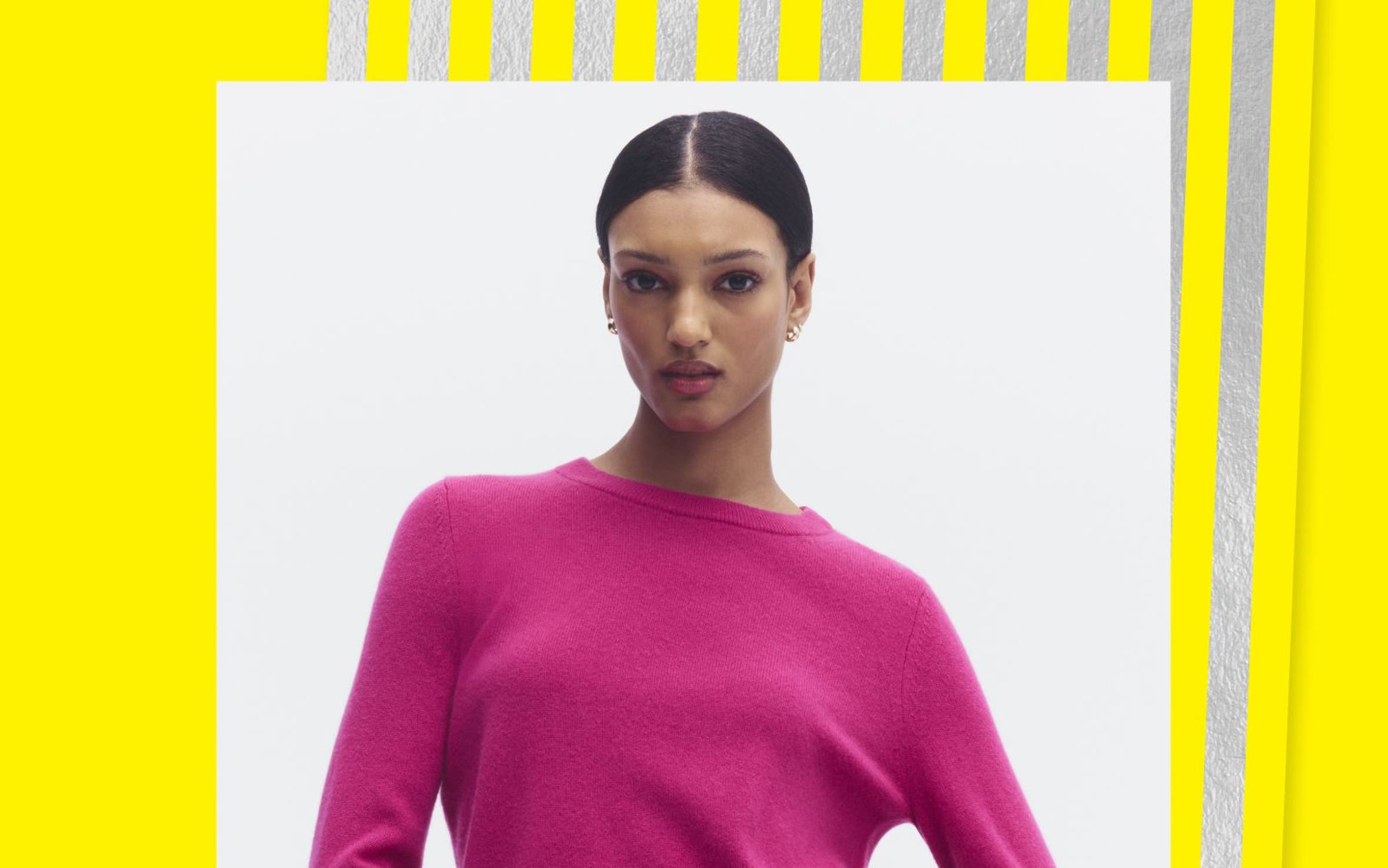 A woman wearing a pink sweater.