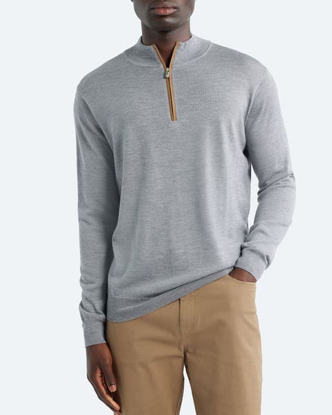 A man wearing a quarter-zip sweater.