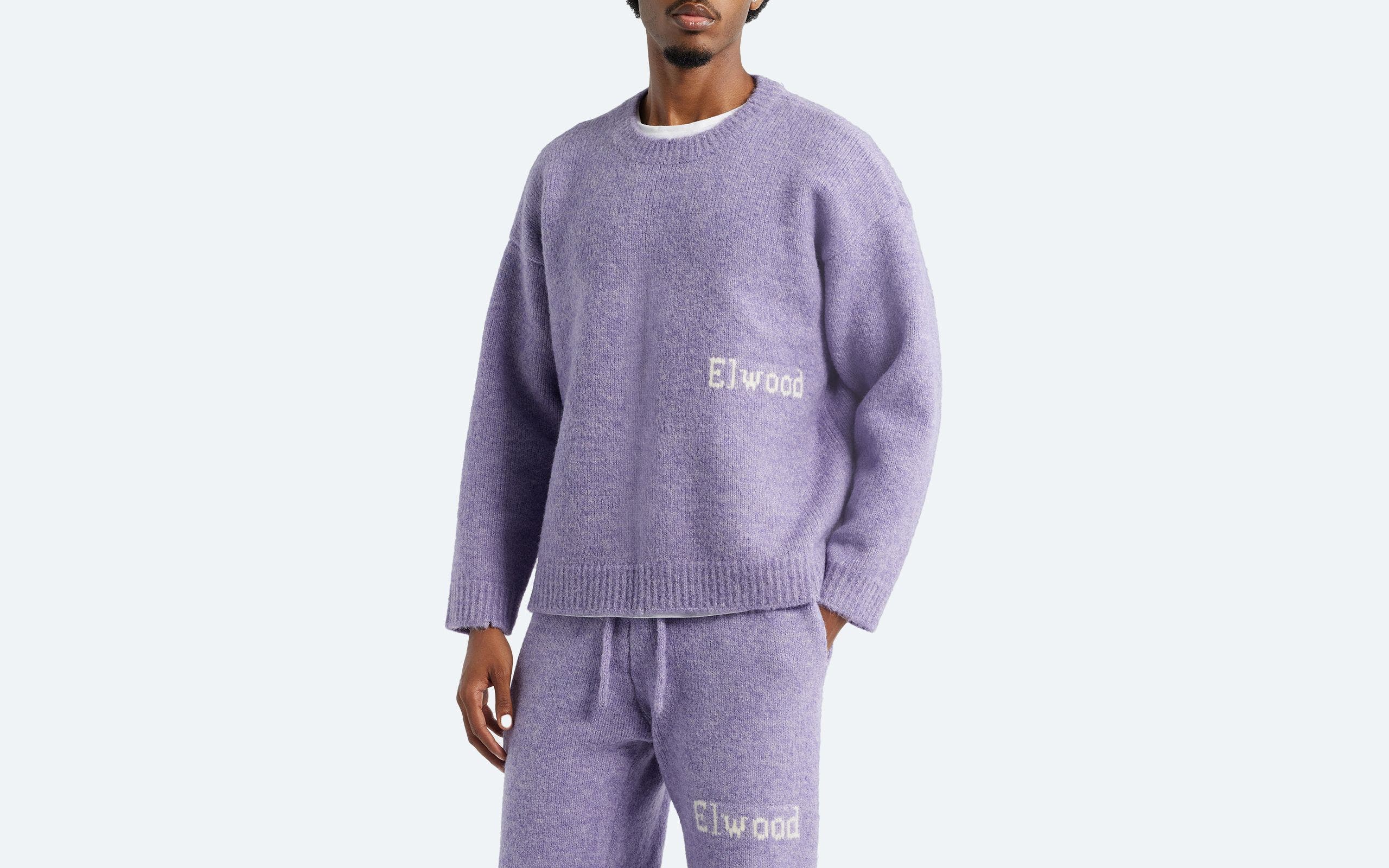 A man wearing a crewneck sweater.