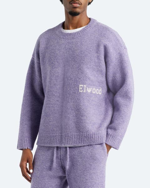 A man wearing a crewneck sweater.