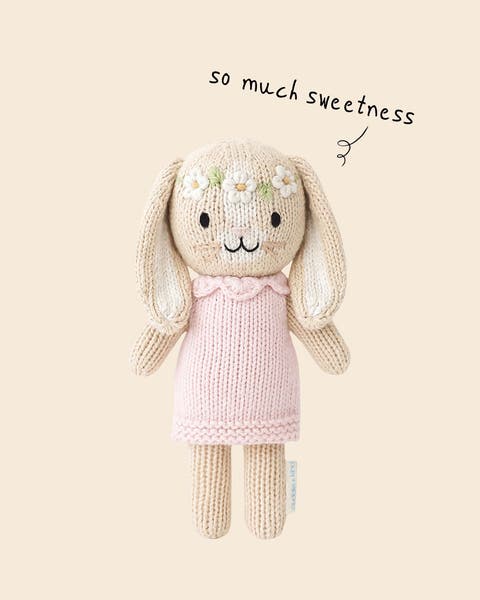 A bunny stuffed animal wearing a flower crown.